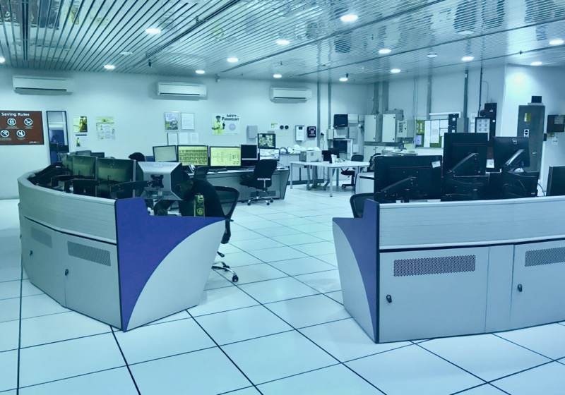 Industrial SCADA control room with operator stations